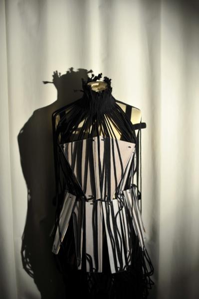 Dress representing restriction through corset and and rope