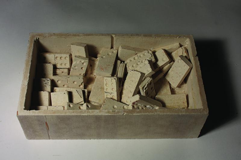 Preservation of the certain moment through casting objects: dominoes and box.
